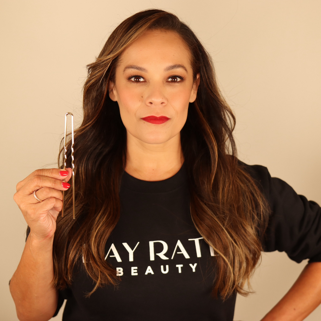 Aviva Jansen Perea, founder of Day Rate Beauty, holding a silver Power Pin
